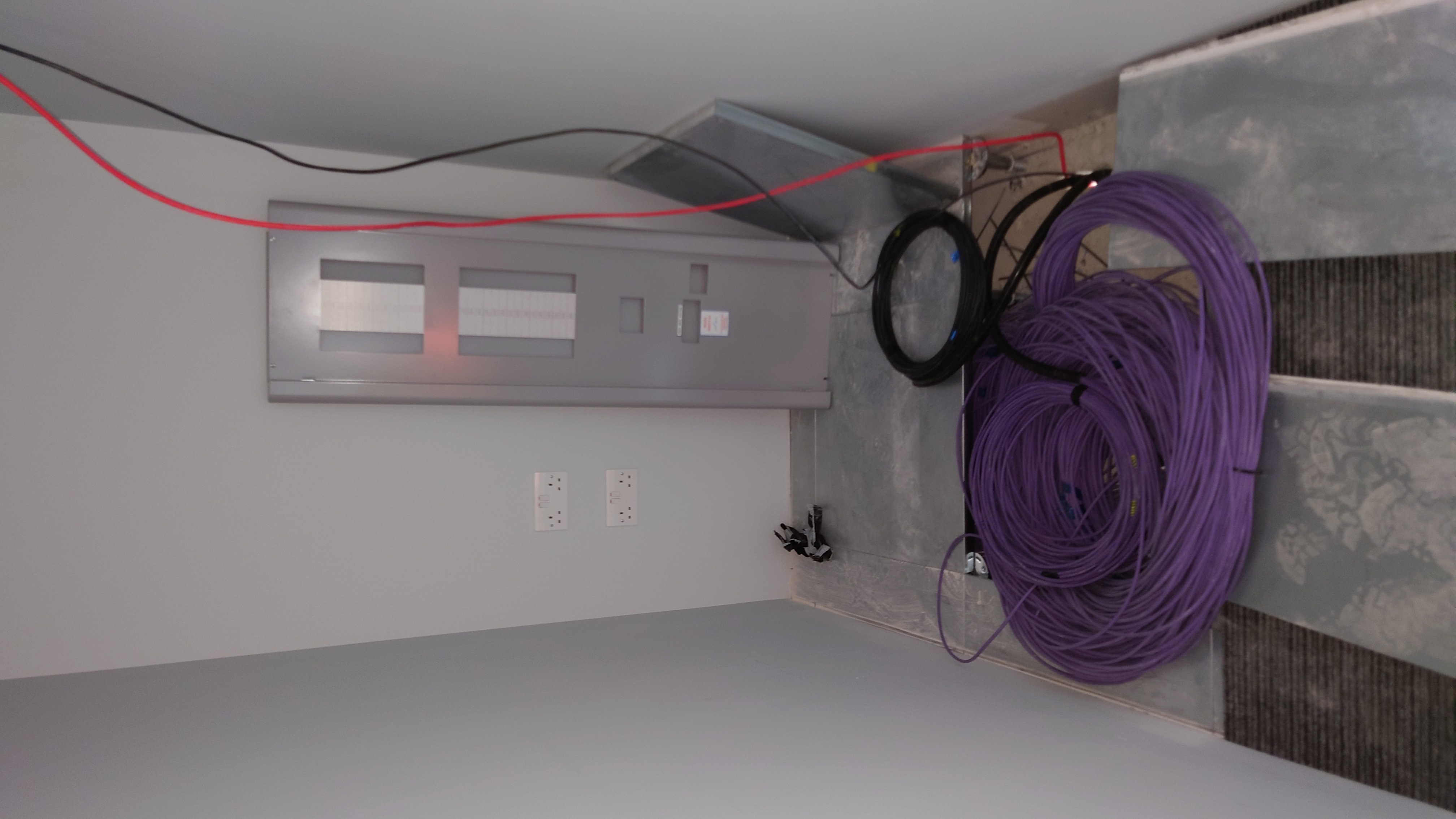 Server room day zero — bare walls and cable coils on the floor